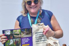 Maria-Noel Vaeza posing with the communication materials produced by Women4Biodiversity