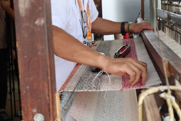 A local artisan shows traditional handloom technique